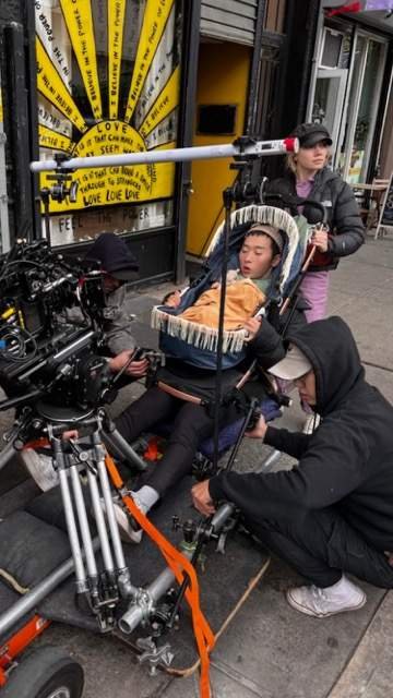 Samon (kneeling) during a location shoot